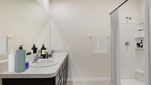full bathroom featuring a stall shower and double vanity