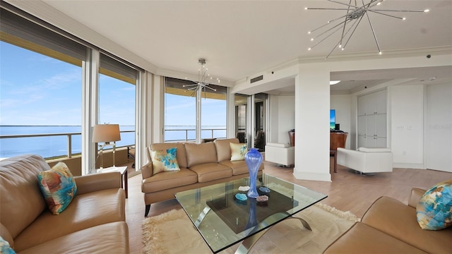 3060 Grand Bay Blvd Unit 182, Longboat Key, FL 34228 - living room featuring a chandelier, wood finished floors, crown molding, and baseboards