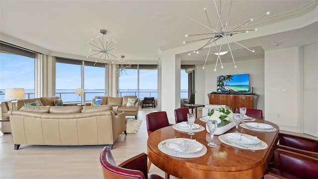 3060 Grand Bay Blvd Unit 182, Longboat Key, FL 34228 - dining space with a chandelier, light wood-style floors, and expansive windows