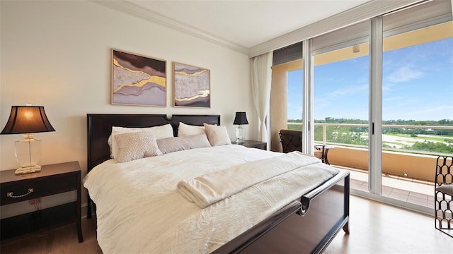 3060 Grand Bay Blvd Unit 182, Longboat Key, FL 34228 - bedroom featuring wood finished floors, ornamental molding, and access to outside