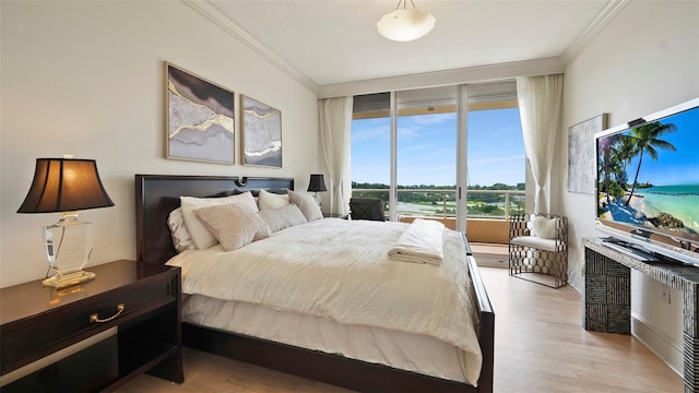 3060 Grand Bay Blvd Unit 182, Longboat Key, FL 34228 - bedroom with ornamental molding and light wood-style flooring