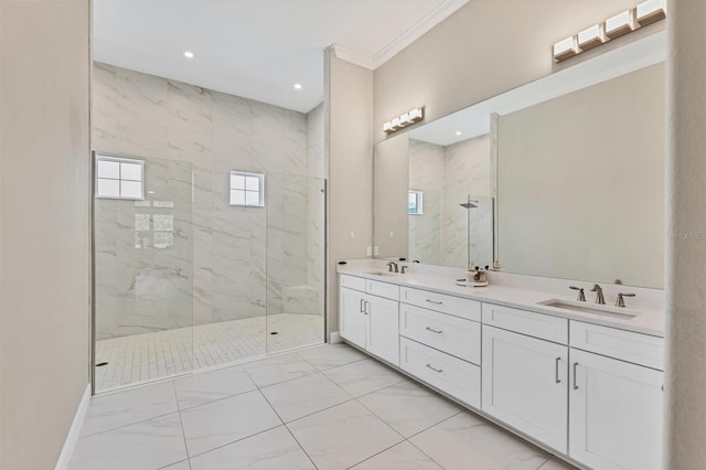 bathroom featuring marble finish floors, a marble finish shower, crown molding, double vanity, and baseboards