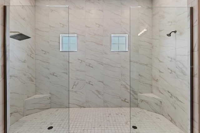 bathroom with tiled shower and healthy amount of natural light