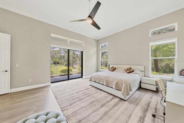 bedroom with access to exterior, light wood-type flooring, baseboards, a ceiling fan, and ornamental molding