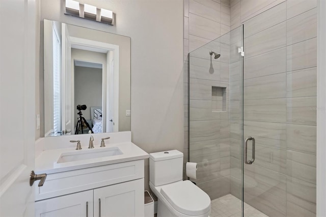 full bathroom with a shower stall, vanity, and toilet