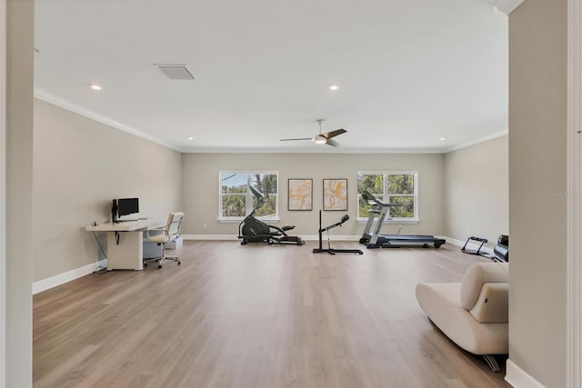 exercise room with baseboards, plenty of natural light, wood finished floors, ornamental molding, and recessed lighting