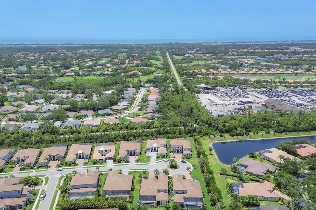 aerial view of property's location featuring a nearby body of water and nearby suburban area