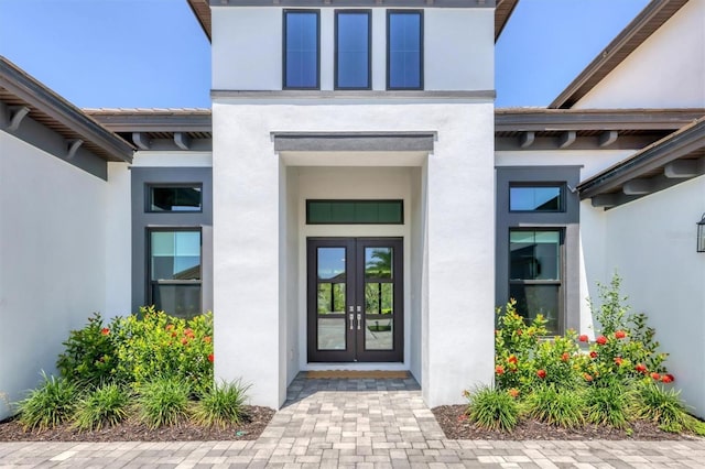 doorway to property with french doors and stucco siding