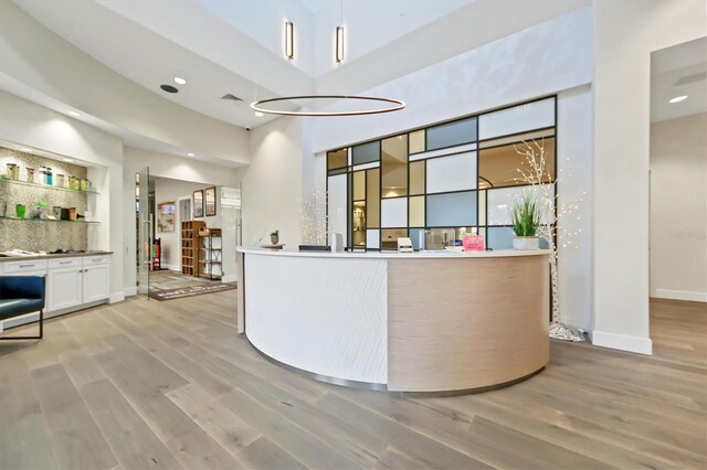 reception featuring a high ceiling and recessed lighting