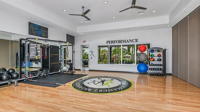 workout area featuring a ceiling fan, recessed lighting, and wood finished floors