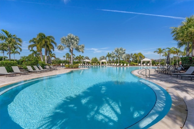 community pool with a patio and a gazebo
