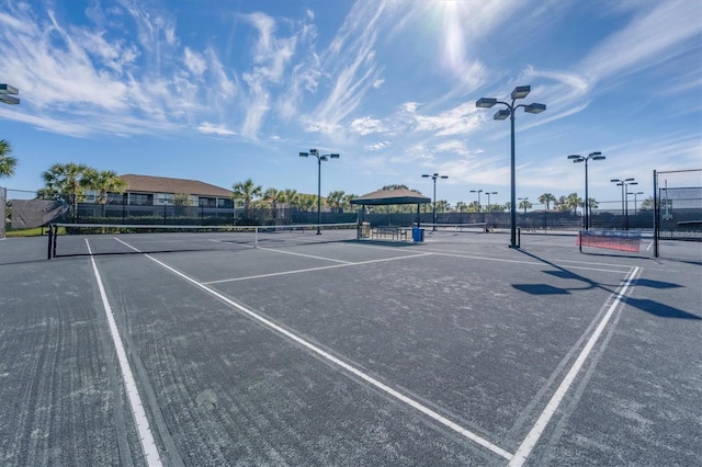 view of tennis court with fence