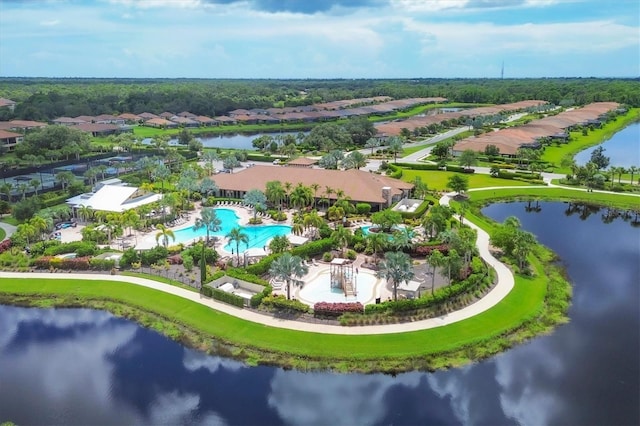 aerial view of residential area featuring a pool and a large body of water