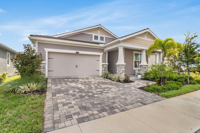 5770 Long Shore Loop, Sarasota, FL 34238 - craftsman-style home featuring decorative driveway, stone siding, and a garage