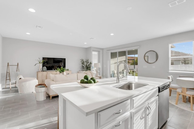 5770 Long Shore Loop, Sarasota, FL 34238 - kitchen featuring stainless steel dishwasher, white cabinets, light countertops, an island with sink, and recessed lighting