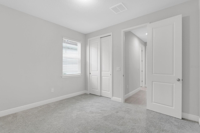 5770 Long Shore Loop, Sarasota, FL 34238 - unfurnished bedroom featuring light colored carpet and a closet