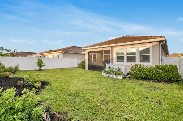 5770 Long Shore Loop, Sarasota, FL 34238 - rear view of property with a fenced backyard, a sunroom, stucco siding, and a tile roof