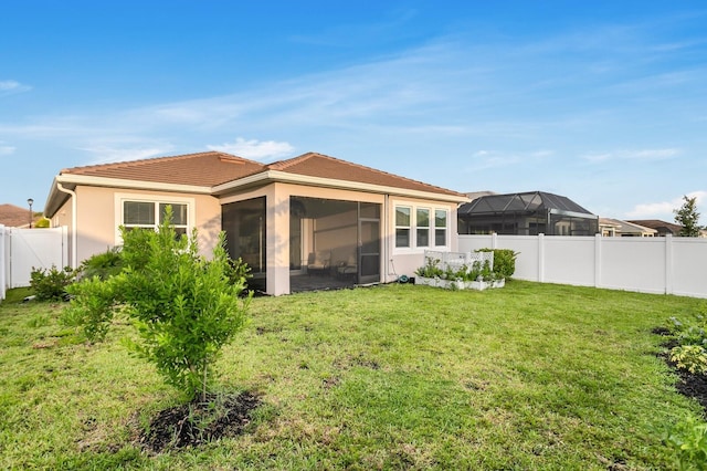 5770 Long Shore Loop, Sarasota, FL 34238 - back of house featuring a sunroom, a fenced backyard, stucco siding, and a tiled roof
