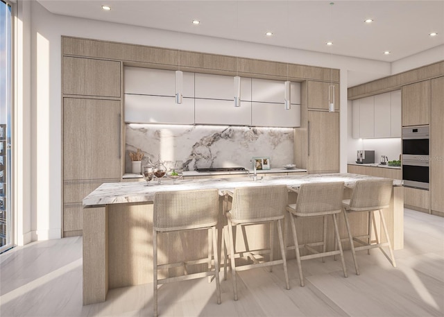 555 Quay Cmn Unit 1005, Sarasota, FL 34236 - kitchen with modern cabinets, decorative backsplash, double oven, a breakfast bar, and recessed lighting