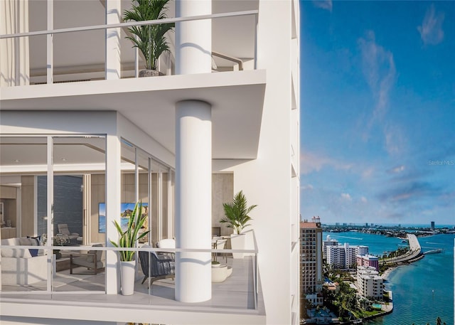 555 Quay Cmn Unit 1005, Sarasota, FL 34236 - doorway to property featuring a water view, a view of city, stucco siding, and a balcony