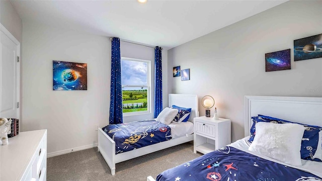 bedroom featuring carpet and baseboards