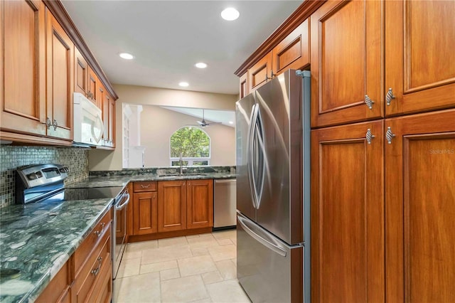 4443 Robin Hood Trl W, Sarasota, FL 34232 - kitchen featuring stainless steel appliances, a sink, brown cabinets, recessed lighting, and tasteful backsplash