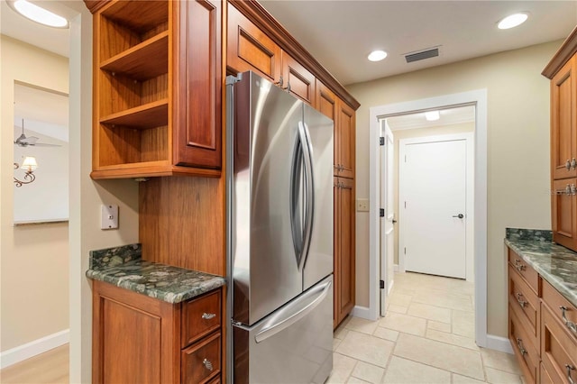 4443 Robin Hood Trl W, Sarasota, FL 34232 - kitchen with freestanding refrigerator, open shelves, dark stone countertops, and brown cabinets