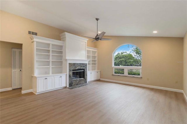 4443 Robin Hood Trl W, Sarasota, FL 34232 - unfurnished living room with light wood-style floors, ceiling fan, baseboards, a high end fireplace, and recessed lighting