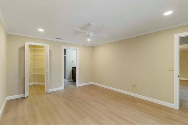 4443 Robin Hood Trl W, Sarasota, FL 34232 - unfurnished bedroom featuring light wood-style floors, recessed lighting, crown molding, a spacious closet, and baseboards