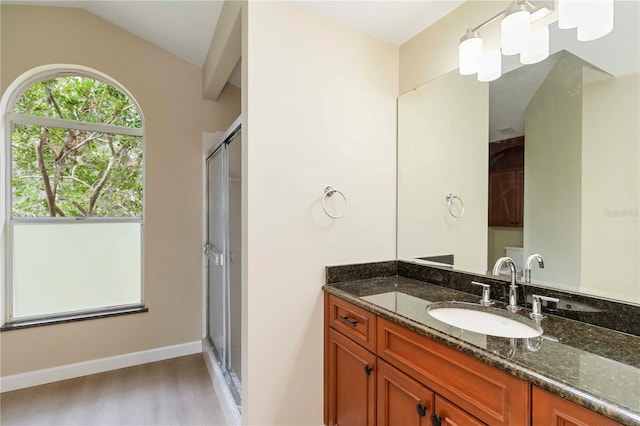 4443 Robin Hood Trl W, Sarasota, FL 34232 - full bath with vanity, wood finished floors, a stall shower, and vaulted ceiling
