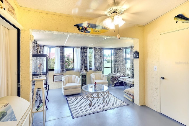 1314 57th St W Unit 1314, Bradenton, FL 34209 - sitting room featuring a textured wall, a ceiling fan, and concrete flooring
