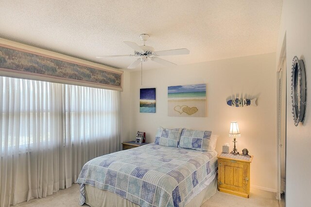 1314 57th St W Unit 1314, Bradenton, FL 34209 - bedroom featuring light carpet, a textured ceiling, ceiling fan, and baseboards