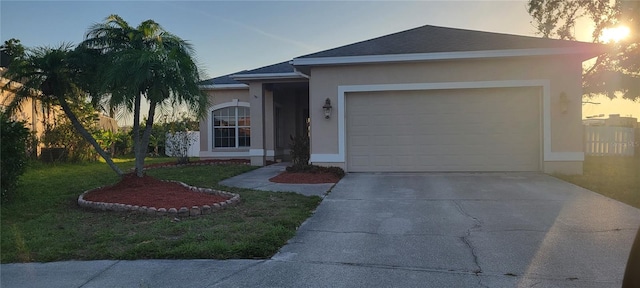 7102 52nd Dr E, Bradenton, FL 34203 - ranch-style home featuring stucco siding, driveway, a yard, an attached garage, and roof with shingles