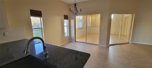 7102 52nd Dr E, Bradenton, FL 34203 - unfurnished dining area with light tile patterned flooring, a sink, a chandelier, and baseboards