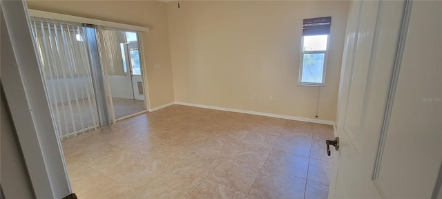 7102 52nd Dr E, Bradenton, FL 34203 - empty room with light tile patterned floors and baseboards
