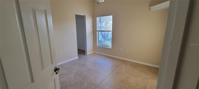 7102 52nd Dr E, Bradenton, FL 34203 - empty room with light tile patterned floors and baseboards