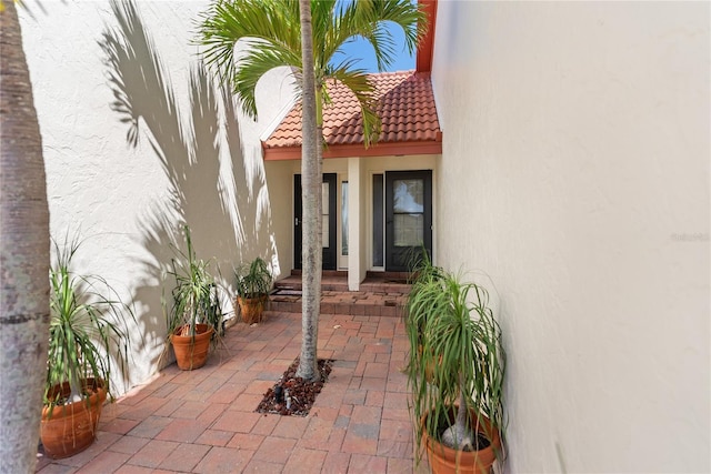 709 Sorrento Inlt Unit 709, Nokomis, FL 34275 - doorway to property featuring stucco siding and a tile roof