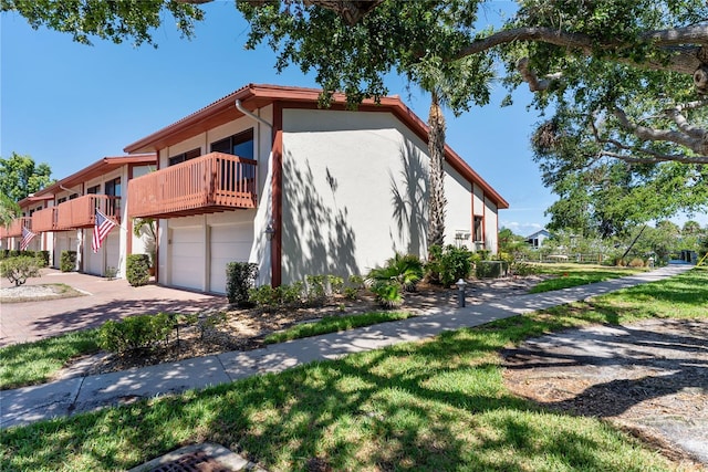 709 Sorrento Inlt Unit 709, Nokomis, FL 34275 - view of property exterior with stucco siding, an attached garage, and concrete driveway