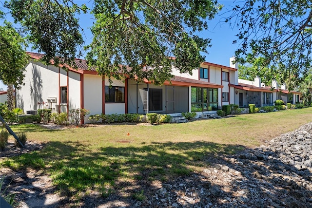 709 Sorrento Inlt Unit 709, Nokomis, FL 34275 - rear view of house with a yard and stucco siding