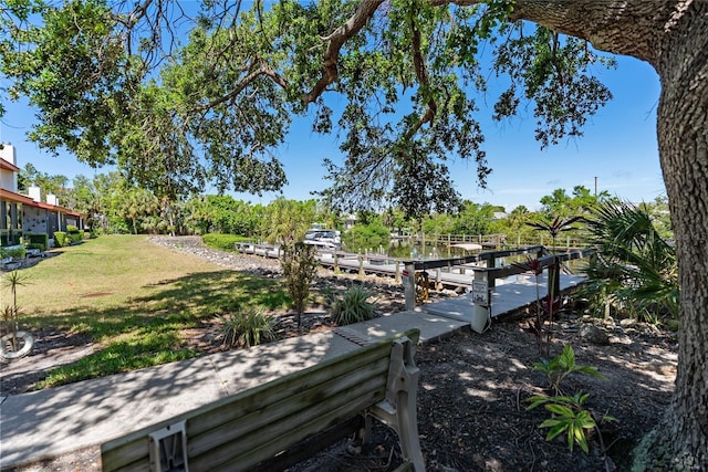 709 Sorrento Inlt Unit 709, Nokomis, FL 34275 - view of grassy yard featuring a boat dock