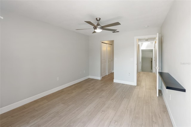 709 Sorrento Inlt Unit 709, Nokomis, FL 34275 - unfurnished bedroom with light wood-style floors, a closet, baseboards, and a ceiling fan