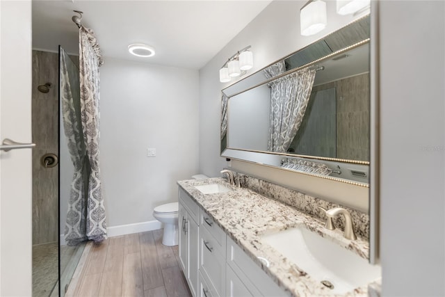 709 Sorrento Inlt Unit 709, Nokomis, FL 34275 - full bathroom with tiled shower, toilet, double vanity, and baseboards