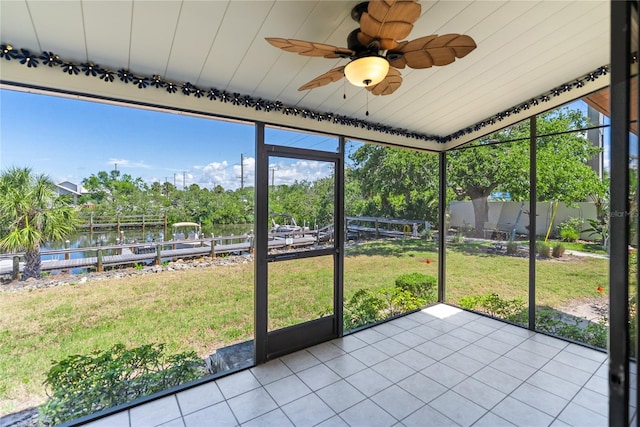 709 Sorrento Inlt Unit 709, Nokomis, FL 34275 - unfurnished sunroom featuring a water view, a ceiling fan, and view of scattered trees
