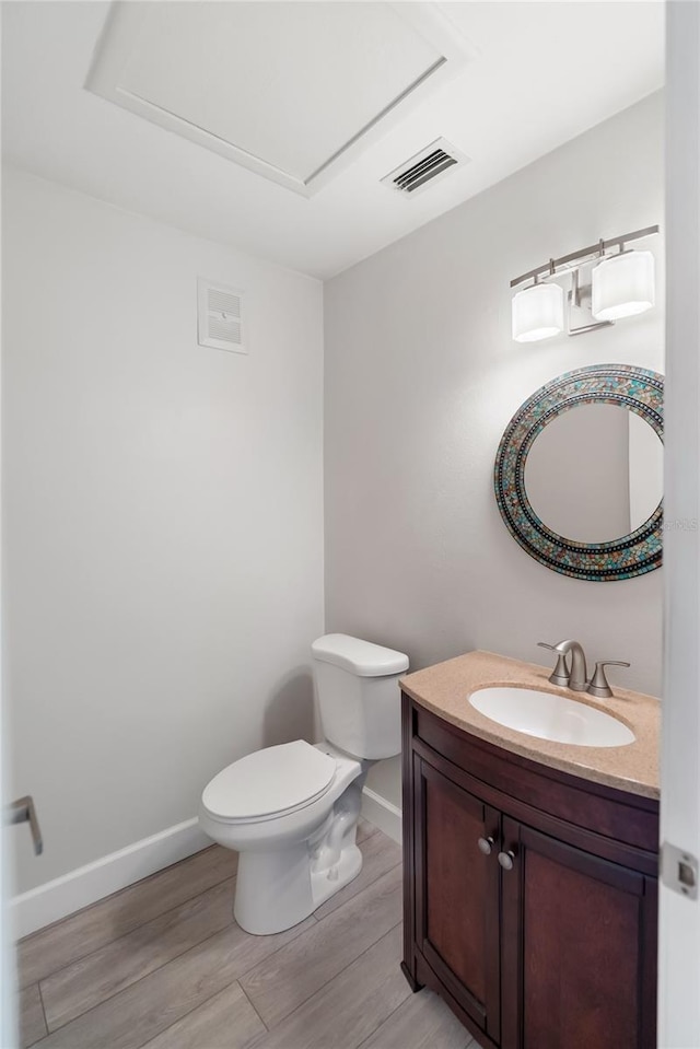 709 Sorrento Inlt Unit 709, Nokomis, FL 34275 - half bath with baseboards, vanity, toilet, and wood finished floors