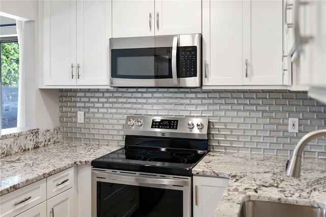709 Sorrento Inlt Unit 709, Nokomis, FL 34275 - kitchen with appliances with stainless steel finishes, a sink, and white cabinets