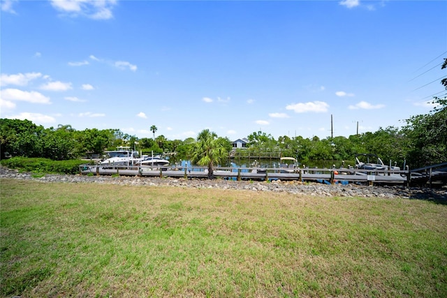 709 Sorrento Inlt Unit 709, Nokomis, FL 34275 - view of green lawn with a dock and view of wooded area