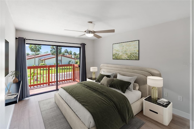 709 Sorrento Inlt Unit 709, Nokomis, FL 34275 - bedroom featuring access to exterior, wood finished floors, baseboards, and ceiling fan