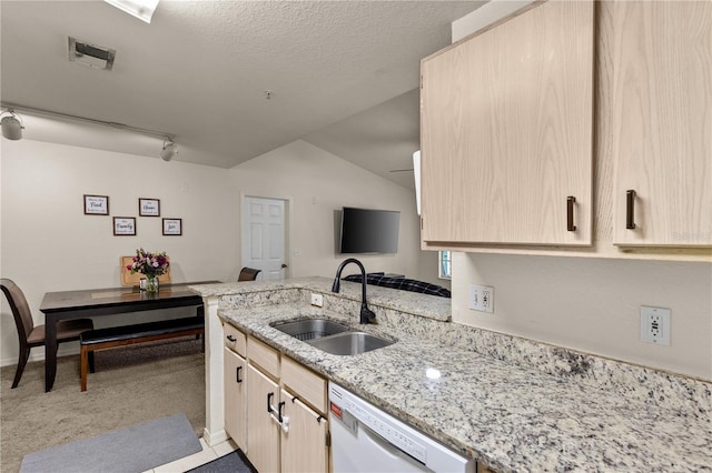 8926 Manor Loop Unit 201, Lakewood Ranch, FL 34202 - kitchen with a sink, white dishwasher, light brown cabinetry, a peninsula, and light stone countertops