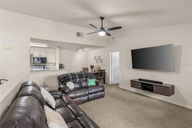 8926 Manor Loop Unit 201, Lakewood Ranch, FL 34202 - carpeted living room with a ceiling fan, vaulted ceiling, and baseboards