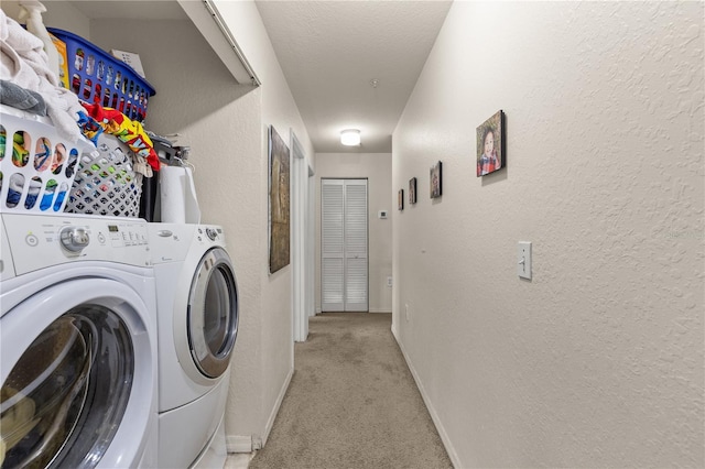 8926 Manor Loop Unit 201, Lakewood Ranch, FL 34202 - laundry area featuring separate washer and dryer, a textured wall, light carpet, and baseboards